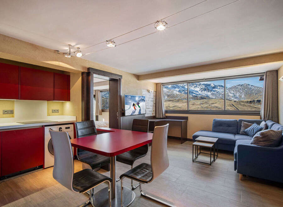 Experience the ultimate mountain retreat in this stunning apartment! Featuring a modern kitchen, a cozy living area with a comfortable sofa, and a dining space perfect for entertaining.