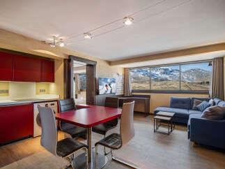 Experience the ultimate mountain retreat in this stunning apartment! Featuring a modern kitchen, a cozy living area with a comfortable sofa, and a dining space perfect for entertaining.