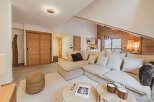 Experience luxury living in this stunning property, featuring a spacious living area with a comfortable sectional sofa and a cozy rug.