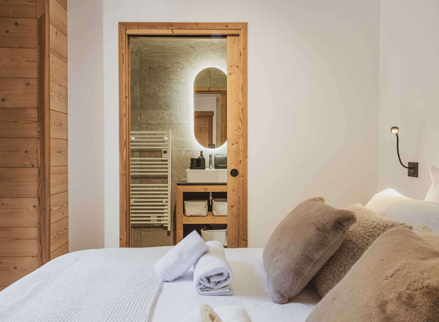 This stunning property boasts a luxurious bedroom with a seamless blend of modern design and rustic charm.