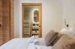 This stunning property boasts a luxurious bedroom with a seamless blend of modern design and rustic charm.