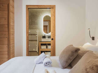 This stunning property boasts a luxurious bedroom with a seamless blend of modern design and rustic charm.