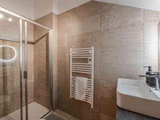 Step into luxury with this stunning bathroom! Featuring a modern shower, heated towel rack, and a sleek sink, this space is designed for ultimate comfort and style.
