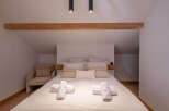 This cozy bedroom features a comfortable bed with soft linens and pillows, perfect for a relaxing retreat.