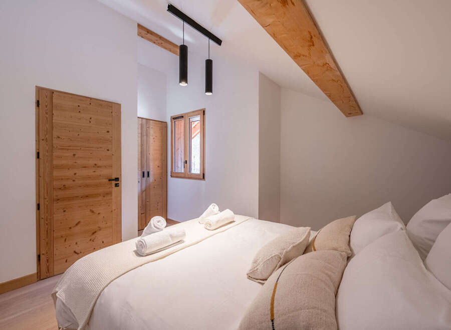 This stunning bedroom boasts a warm and inviting atmosphere, perfect for relaxation.