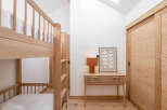 This cozy bedroom features a stylish bunk bed, perfect for accommodating guests or family members.
