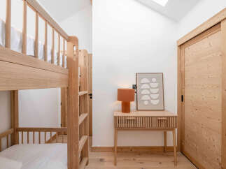 This cozy bedroom features a stylish bunk bed, perfect for accommodating guests or family members.