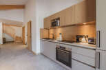 This modern kitchen boasts sleek cabinetry and a built-in microwave, perfect for preparing meals.
