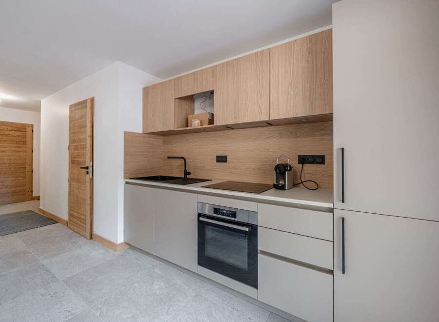 This modern kitchen boasts sleek cabinetry and a minimalist design, perfect for contemporary living.