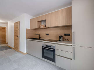 This modern kitchen boasts sleek cabinetry and a minimalist design, perfect for contemporary living.