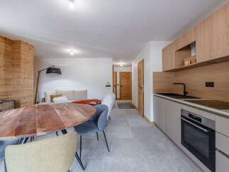 Discover the charm of this beautifully designed property, featuring a modern kitchen with sleek cabinetry and a built-in oven.
