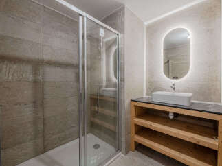 Step into a modern bathroom oasis! This stunning space features a sleek glass shower enclosure, perfect for a refreshing start to your day.