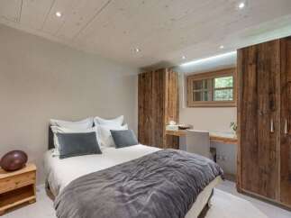This cozy bedroom features a comfortable bed with plush pillows and a stylish gray comforter.