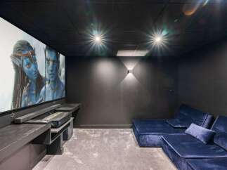 Step into luxury with this stunning home theater! Featuring a large screen, comfortable seating, and a sleek, modern design, this space is perfect for movie nights and entertaining guests.