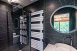 This luxurious bathroom boasts a sleek, modern design with striking black marble walls.