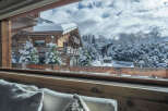Experience the charm of this stunning wooden chalet nestled in a winter wonderland.