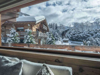 Experience the charm of this stunning wooden chalet nestled in a winter wonderland.