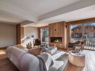 Experience luxury living in this stunning property featuring a cozy fireplace and expansive windows.