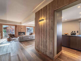 This stunning property boasts a warm and inviting interior with beautiful wooden accents throughout.