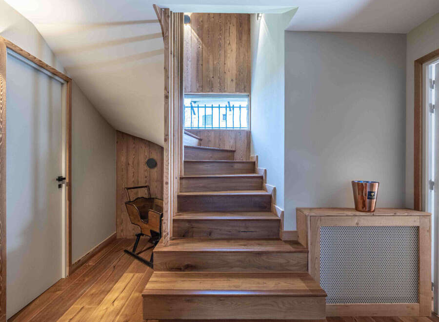This stunning property boasts a beautifully crafted wooden staircase, adding warmth and character to the interior.