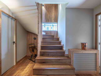 This stunning property boasts a beautifully crafted wooden staircase, adding warmth and character to the interior.