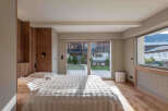 This stunning bedroom boasts a seamless blend of modern design and natural elements.