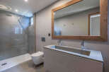 Step into a modern bathroom oasis, featuring a sleek shower and a stylish vanity.