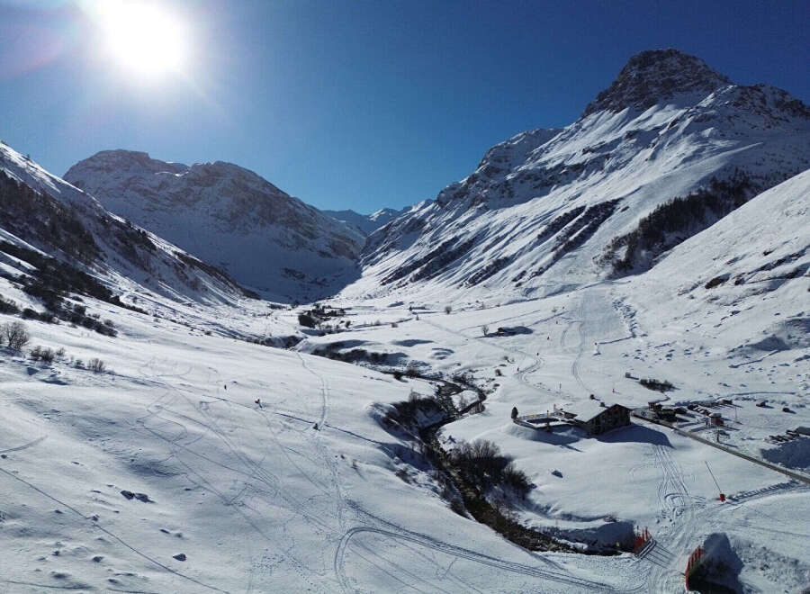 Explore the breathtaking beauty of this mountain property, nestled in a serene winter wonderland.