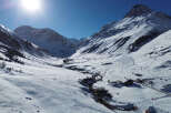 Explore the breathtaking beauty of this mountain property, nestled in a serene winter wonderland.