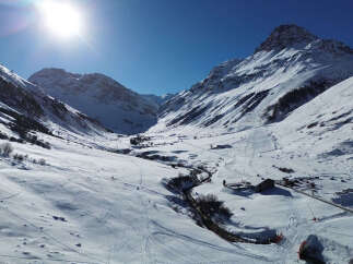 Explore the breathtaking beauty of this mountain property, nestled in a serene winter wonderland.