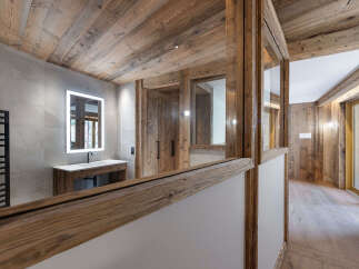 Experience rustic luxury in this stunning bathroom featuring natural wood accents and modern amenities.