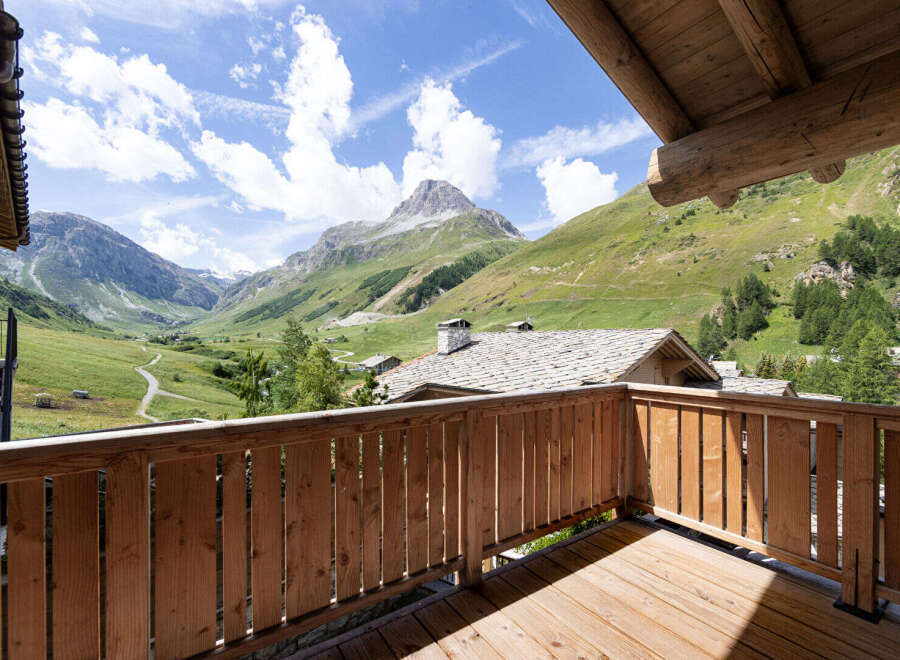 Experience breathtaking mountain views from this charming wooden balcony, perfect for enjoying your morning coffee or evening wine.