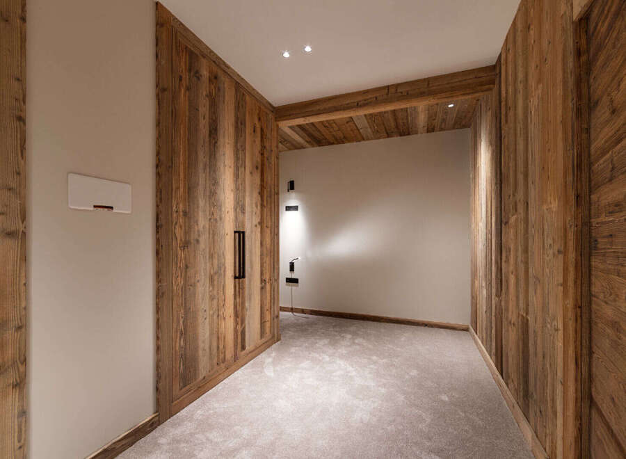 Experience rustic charm and modern comfort in this beautifully appointed room, featuring warm, natural wood paneling throughout.