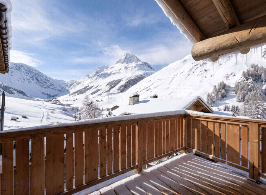 Experience breathtaking mountain views from this charming wooden balcony, perfect for enjoying your morning coffee or evening relaxation.