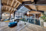Experience luxury living in this stunning property, featuring a unique glass floor and exposed wooden beams that create a warm and inviting atmosphere.