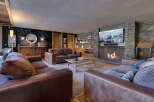 Experience luxury living in this stunning property, featuring a cozy living room with a fireplace and a large TV.
