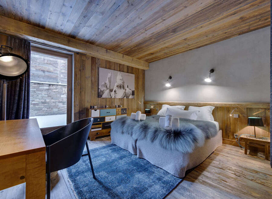 Experience rustic luxury in this stunning bedroom.