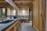 Step into luxury with this stunning bathroom featuring rustic wooden accents and modern amenities.
