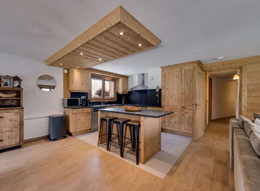This stunning kitchen boasts a rustic charm with its wooden cabinetry and island, creating a warm and inviting atmosphere.
