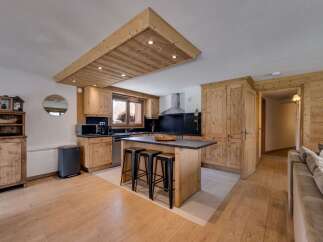 This stunning kitchen boasts a rustic charm with its wooden cabinetry and island, creating a warm and inviting atmosphere.