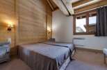This cozy bedroom features a rustic wooden interior, creating a warm and inviting atmosphere.