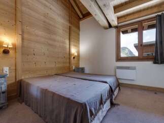 This cozy bedroom features a rustic wooden interior, creating a warm and inviting atmosphere.