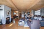 Experience the warmth of this stunning chalet, featuring a cozy fireplace and inviting wooden beams.