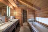 Experience luxury in this stunning bathroom featuring a sleek double vanity with granite countertops and ample storage.