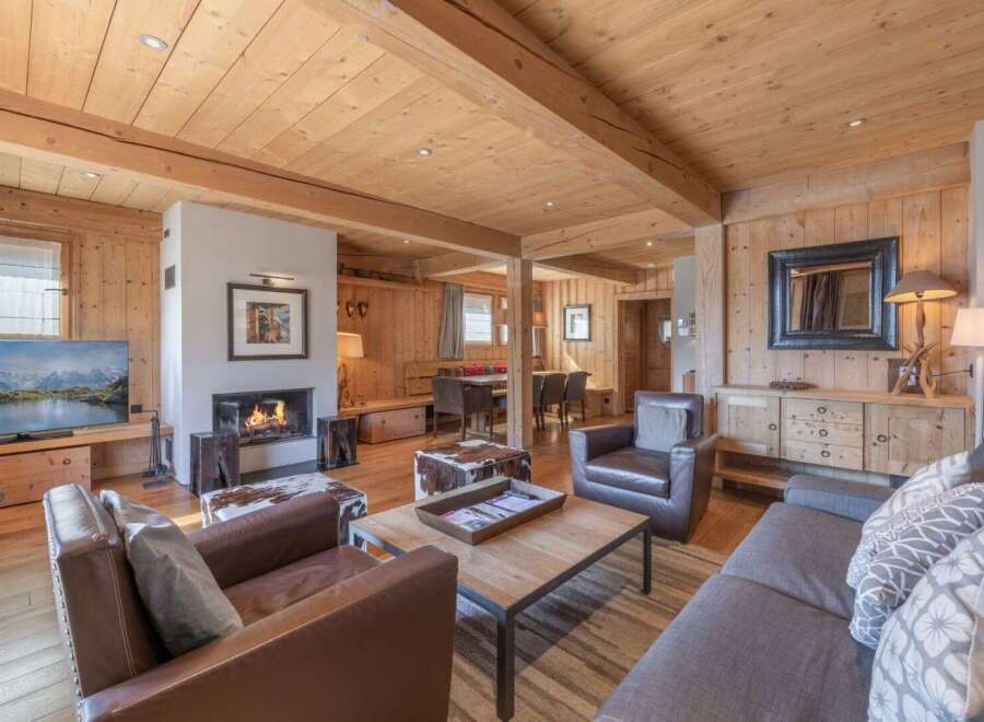 Experience the warmth and charm of this stunning living space, featuring a cozy fireplace and inviting leather seating.