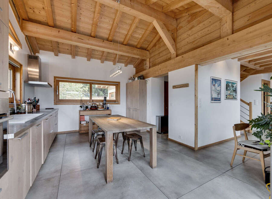 This stunning kitchen boasts a rustic charm with its exposed wooden beams and a spacious layout.