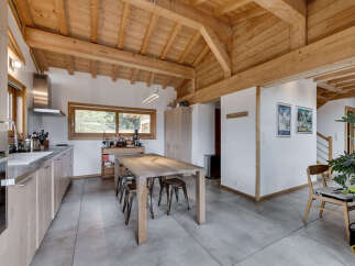 This stunning kitchen boasts a rustic charm with its exposed wooden beams and a spacious layout.