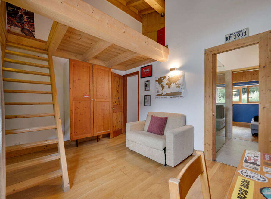 This charming property boasts a unique loft-style design with exposed wooden beams and a cozy living area.