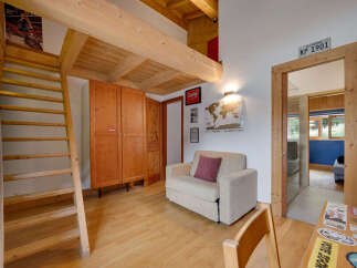 This charming property boasts a unique loft-style design with exposed wooden beams and a cozy living area.