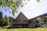 Experience luxury mountain living in this stunning wooden chalet, featuring a striking A-frame design and expansive wrap-around balconies offering breathtaking views.